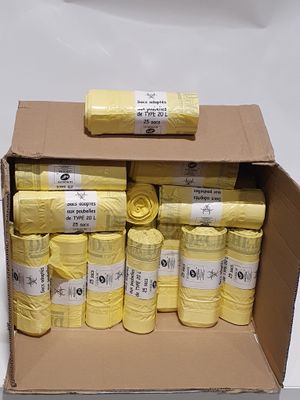 boxes of yellow yarn sitting on top of each other on a white surface