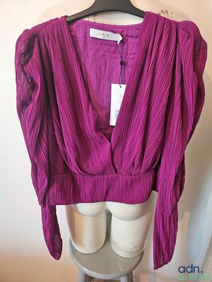a close up of a purple top on a mannequin mannequin