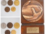 four different images of a plaque with a hand holding a coin