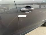 a close up of a car door handle with a sticker on it