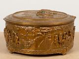 a gold box with a design on it on a table