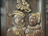 a wooden plaque with a picture of two people on it