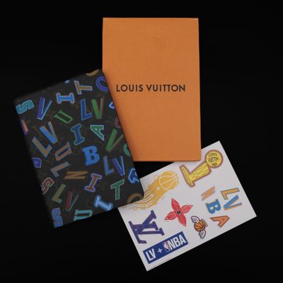 louis vuitton passport cover and stickers on a black background