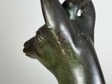a close up of a statue of a deer with a bird on it ' s head