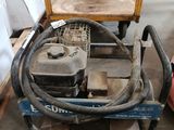 a small machine that is sitting on a pallet in a warehouse