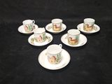 six cups and saucers with animals on them sitting on a black surface