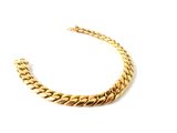 a close up of a gold necklace on a white background