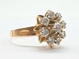 an image of a gold ring with a cluster of diamonds