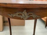 a wooden table with a metal decoration on it