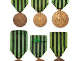 six medals of different colors and designs on a white background