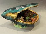 a small shell with shells inside of it on a table