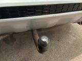 a close up of a white car with a black exhaust pipe