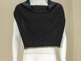 a mannequin wearing a black top with a chain around the neck
