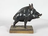 statue of a boar on a wooden base on a white background