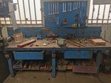 a workbench with tools on it in a garage
