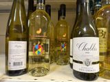 several bottles of wine are lined up on a shelf in a store