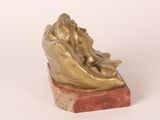 statue of a woman laying on her back on a marble base