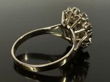 a close up of a diamond ring on a black surface