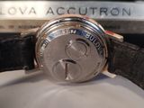 a close up of a watch on a white surface