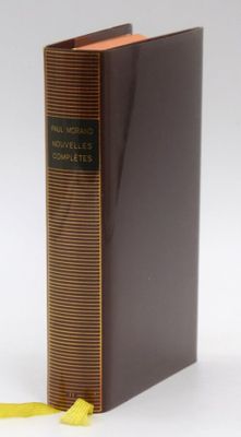 an old book with a yellow ribbon on top of it