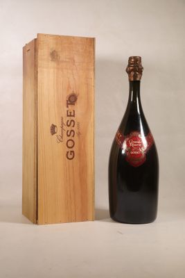 a bottle of wine sitting next to a wooden box