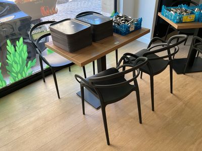 tables and chairs in a room with a fish tank in the background