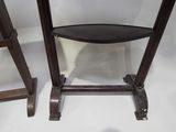 two wooden stools sitting next to each other on a white surface