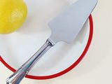 a plate with a knife and a lemon on it