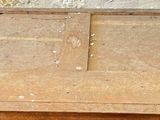 an old wooden table with a drawer on top of it