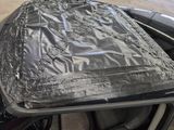 a car with a tarp on top of it