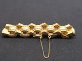 a close up of a gold chain on a black surface