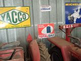 many signs on the wall of a building with a tractor