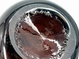 a close up of a glass bottle with a liquid inside of it