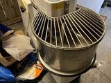 a mixer sitting on the floor next to a trash bag