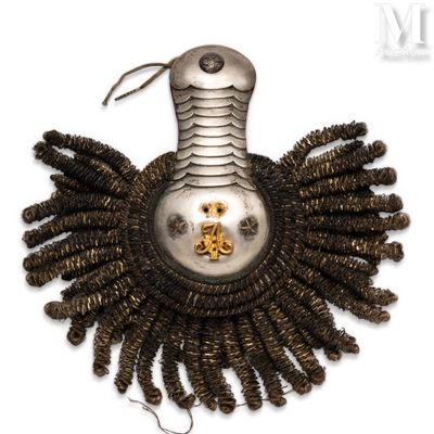 a silver and gold brooch on a white background