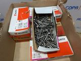 a box of screws sitting on top of a cardboard box