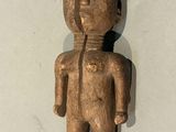 wooden figurine of a man with a hat on his head
