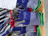 many pairs of gloves in a box on the floor