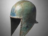 a bronze helmet on a gray background