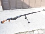 a rifle that is sitting on a stand on the sidewalk