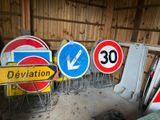 many different street signs in a row in a garage