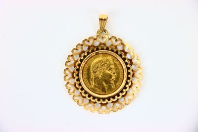 an image of a gold coin in a pendant on a white surface