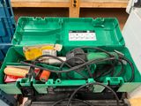a green box with tools in it sitting on a pallet