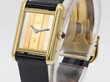 an image of a gold and black wrist watch with a black band