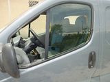 a silver van with the door open and the driver ' s seat down