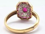 an image of a gold ring with a pink stone in it