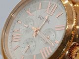 a gold watch with roman numerals on the face