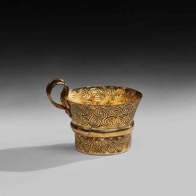 an image of a gold cup sitting on top of a table