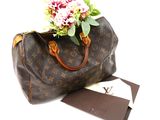 a brown louis vuitton bag with flowers in it