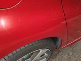 a close up of a red car with the door open